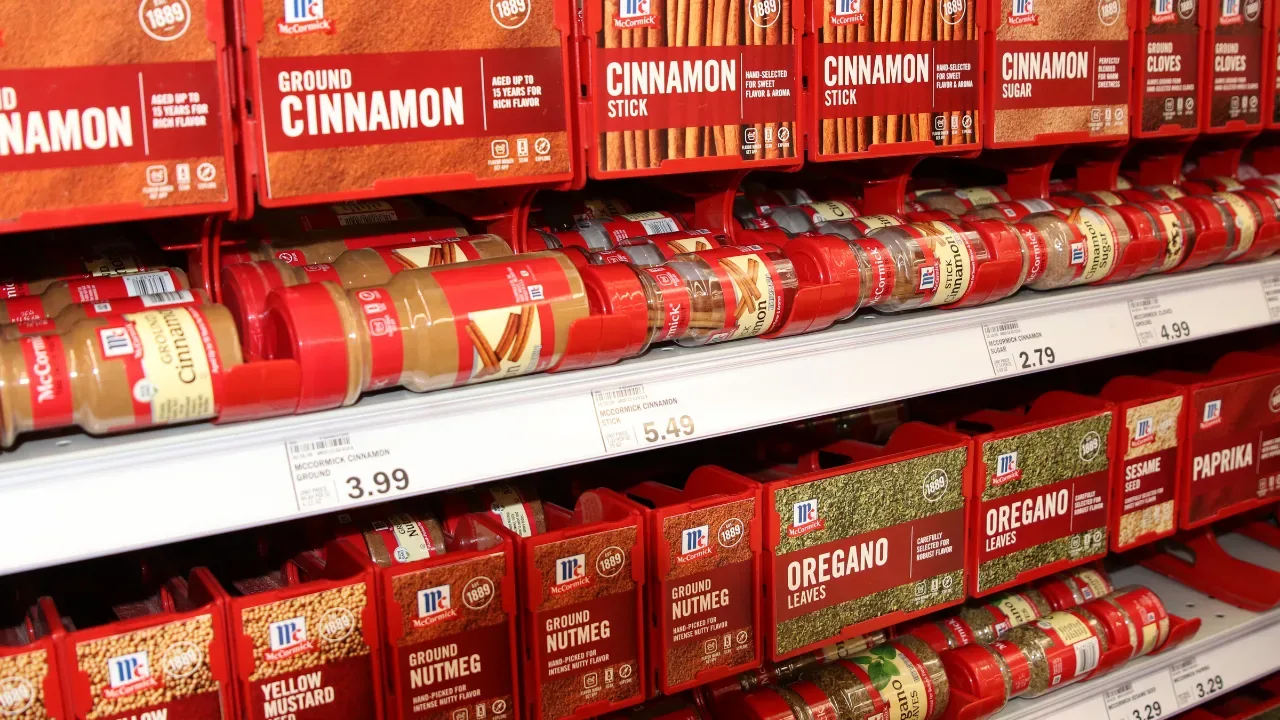 Supermarket shelf full of Cassia cinnamon jars